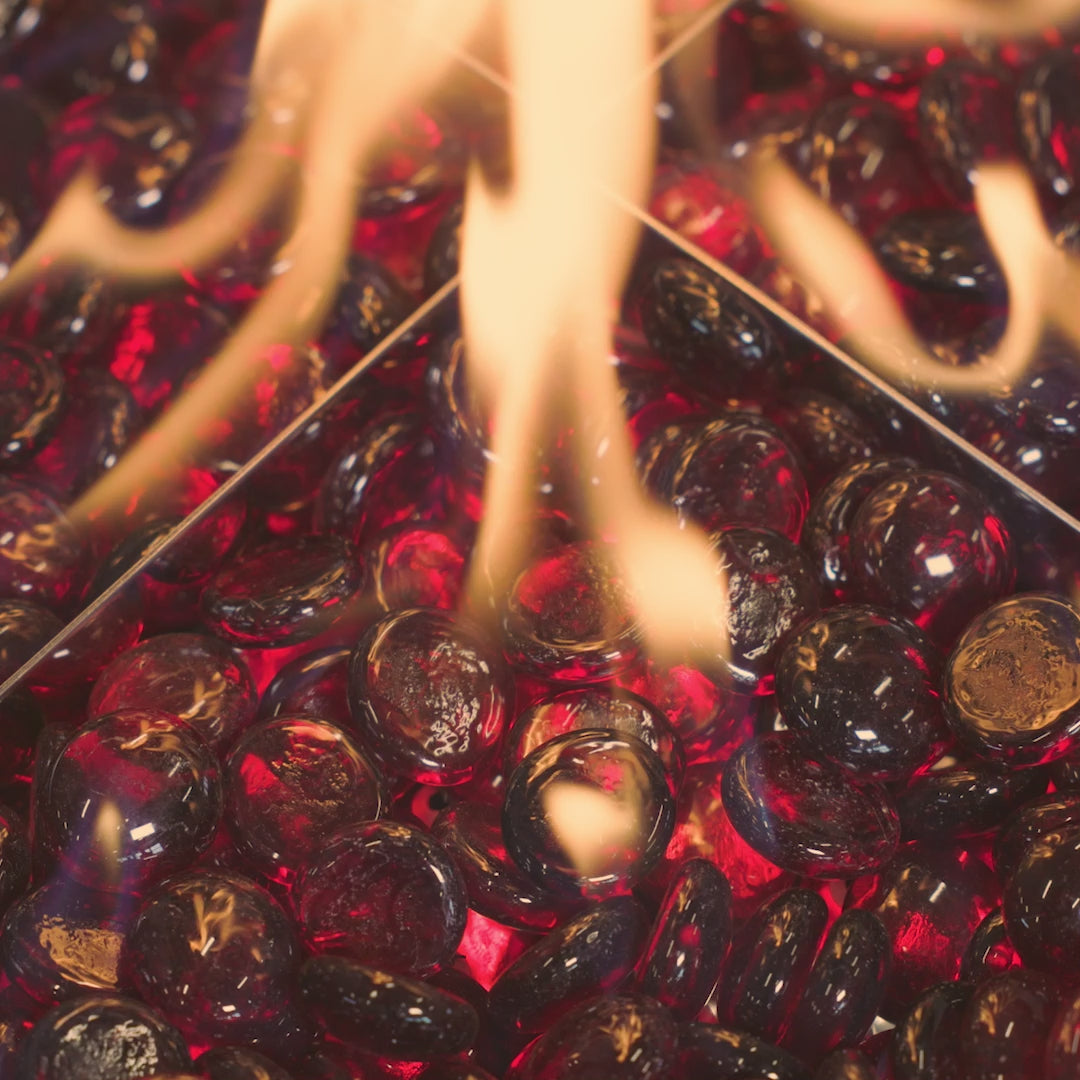 A video of a flame reflecting off the Ruby Tempered Fire Glass Gems