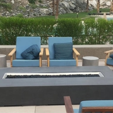 A patio setup with a linear gas fire pit table and patio furniture