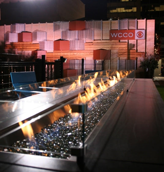 A custom linear gas fire pit table for WCCO